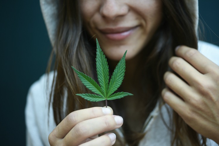 effects of cannabis woman holding leaf